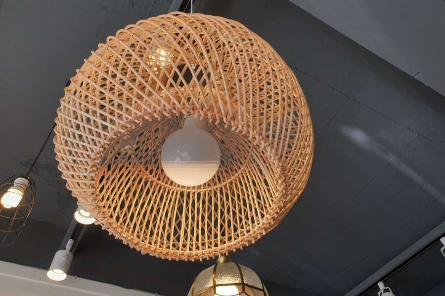 A large woven rattan shade demonstrating proportional pendant light sizing for spacious rooms.